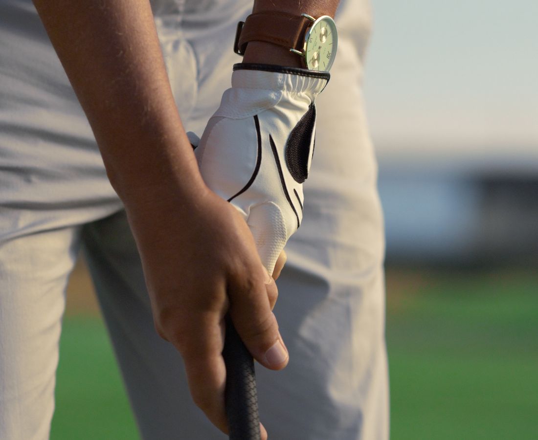 Man outdoors holding golf club ready to play — active life without skin discomfort